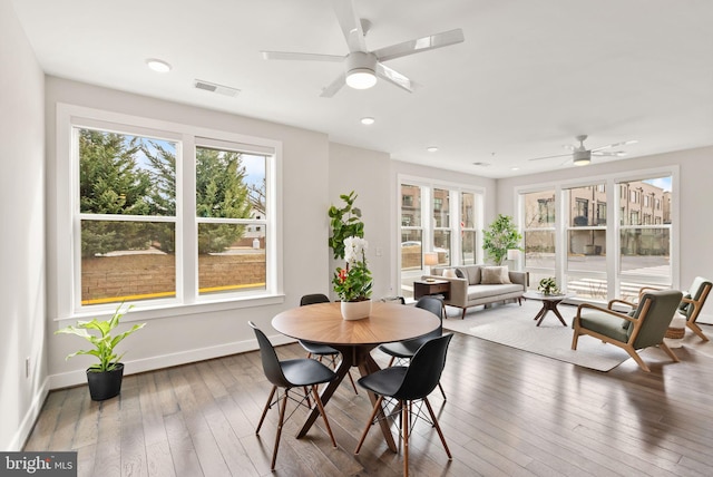 sunroom / solarium featuring ceiling fan