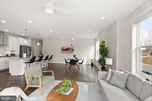 living room featuring dark hardwood / wood-style floors and ceiling fan