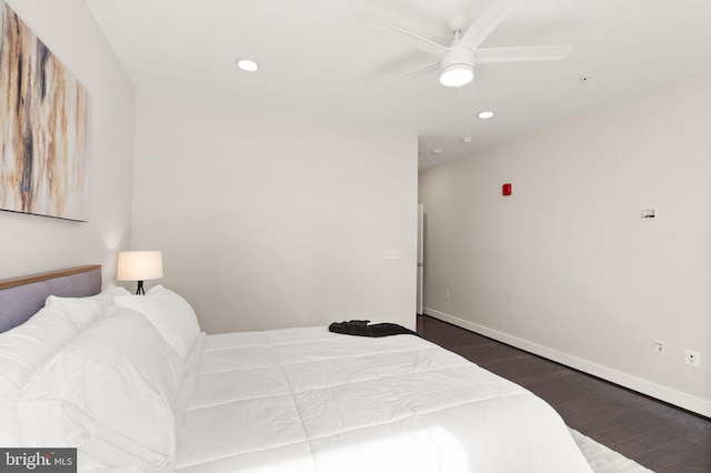 bedroom with dark hardwood / wood-style floors and ceiling fan