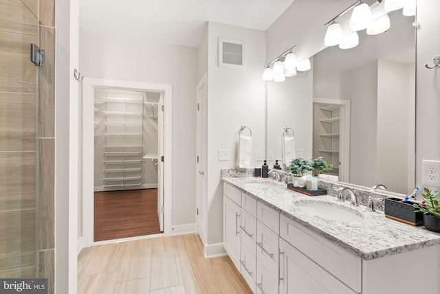 bathroom featuring vanity and walk in shower