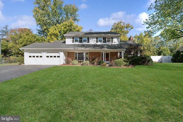 front of property featuring a garage and a front lawn