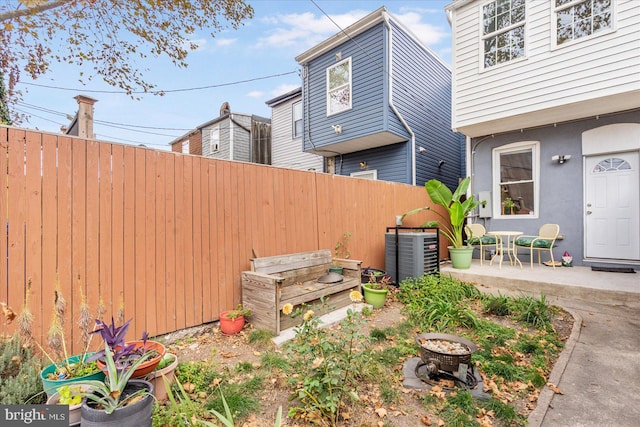 view of yard with central AC unit and a patio