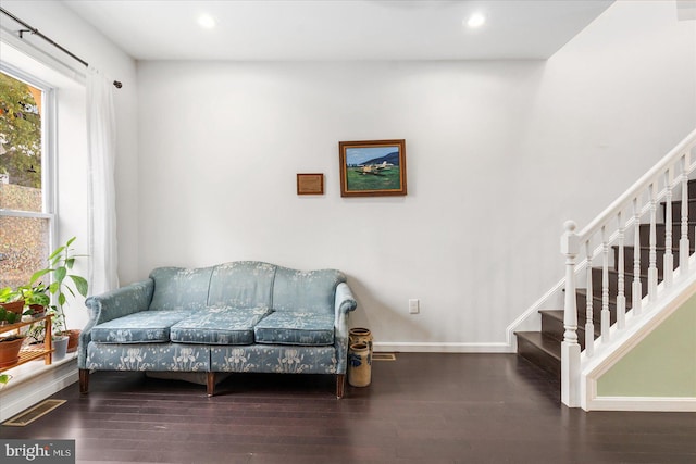 sitting room with dark wood-type flooring