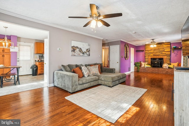 living room with light hardwood / wood-style floors, crown molding, a textured ceiling, and ceiling fan