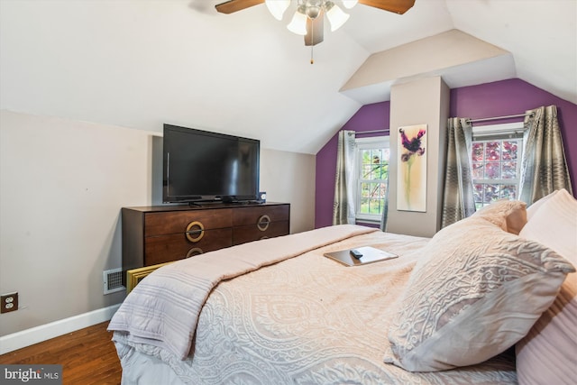 bedroom with ceiling fan, vaulted ceiling, and hardwood / wood-style floors