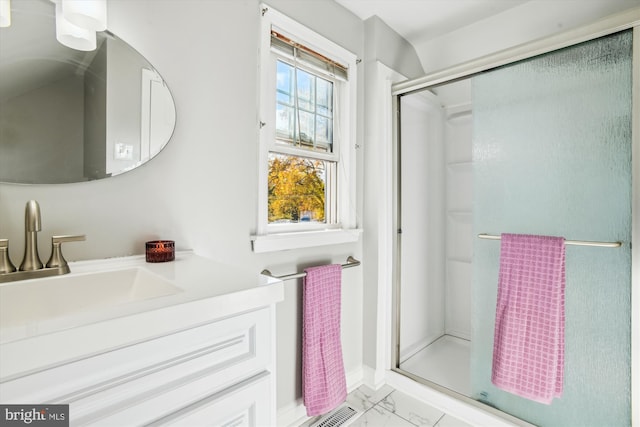 bathroom featuring vanity and a shower with shower door