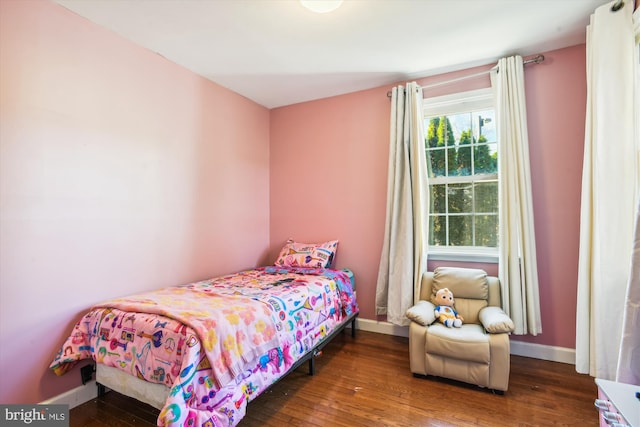 bedroom with dark hardwood / wood-style flooring