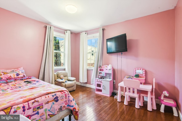 bedroom with dark hardwood / wood-style floors