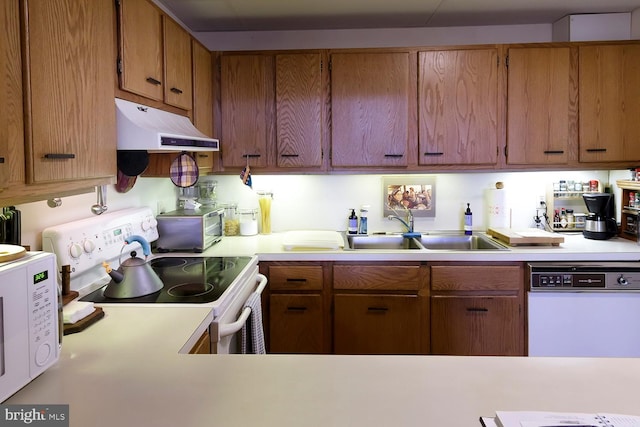 kitchen featuring sink and white appliances