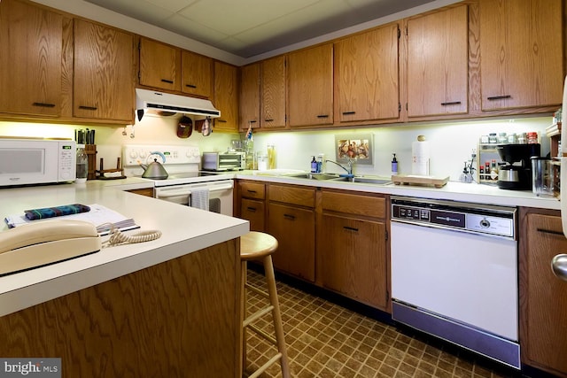 kitchen featuring white appliances and sink