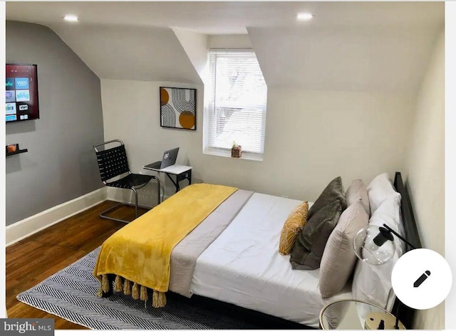 bedroom featuring wood-type flooring and vaulted ceiling