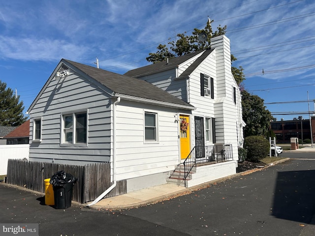 893 Parkway Ave, Ewing, NJ 08618 - view of front facade with a chimney, fence, and a shingled roof