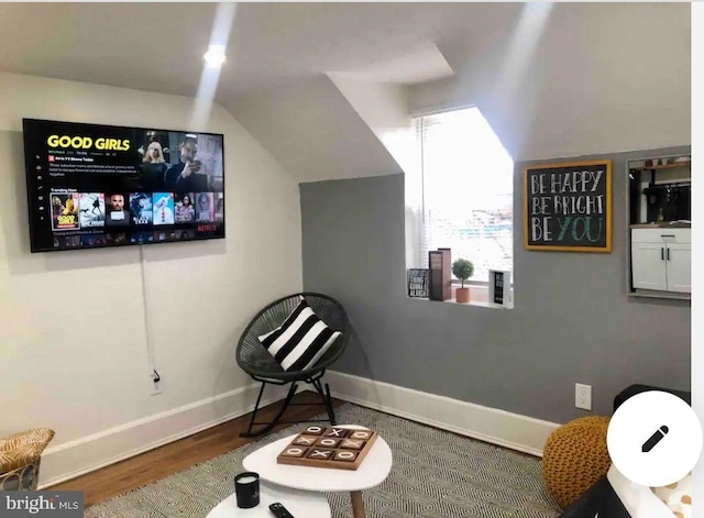 sitting room with hardwood / wood-style flooring and lofted ceiling