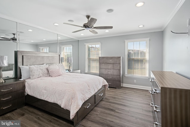 bedroom with ceiling fan, crown molding, dark wood-type flooring, and multiple windows