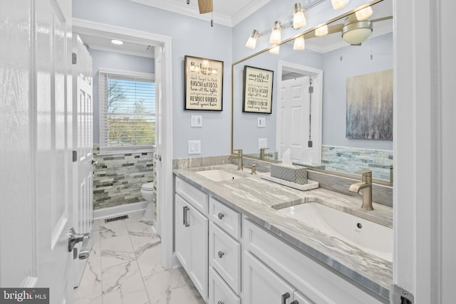 bathroom with crown molding, vanity, and toilet