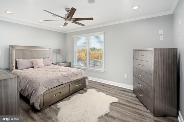 bedroom featuring wood-type flooring, ornamental molding, and ceiling fan