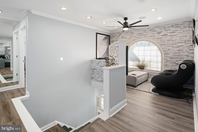 interior space with crown molding, ceiling fan, and wood-type flooring