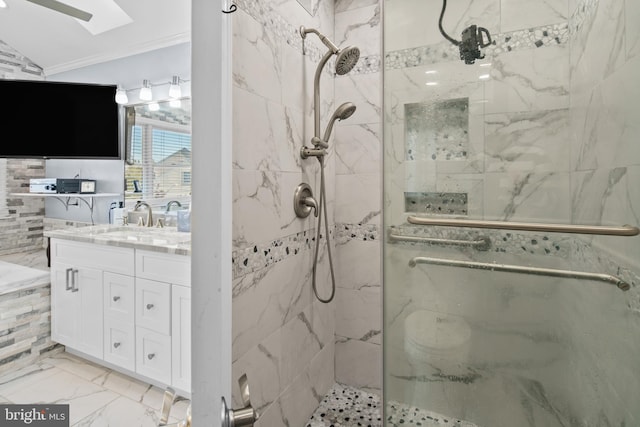 bathroom with crown molding, a shower with door, a skylight, and vanity