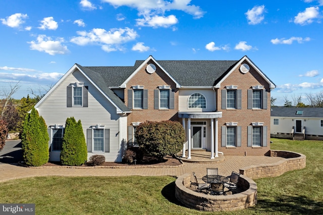 view of front of property with a fire pit and a front yard