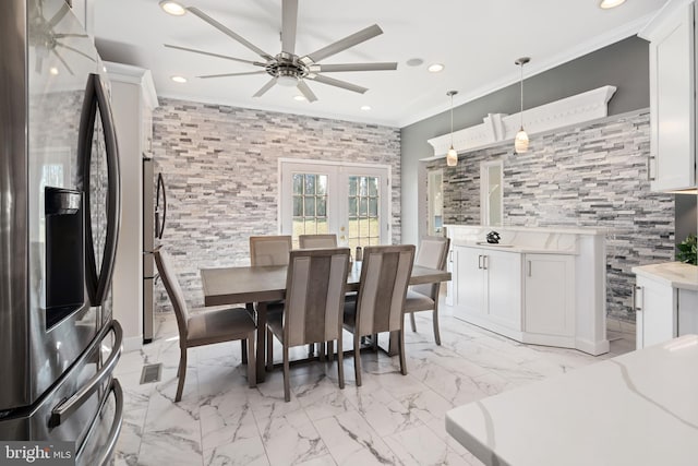 dining space featuring french doors, crown molding, and ceiling fan