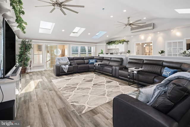 living room with lofted ceiling, ceiling fan, a wall mounted AC, and light hardwood / wood-style flooring