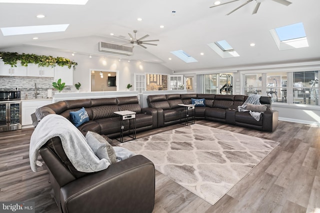 living room with sink, light hardwood / wood-style floors, crown molding, vaulted ceiling, and wine cooler