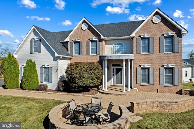 view of front of house with a patio area and a front lawn