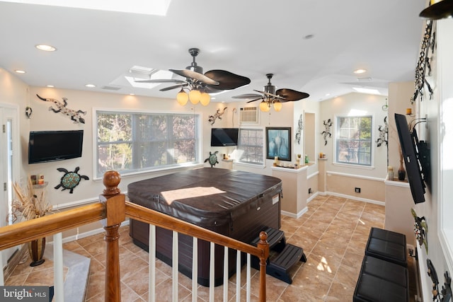 interior space featuring ceiling fan, plenty of natural light, and lofted ceiling with skylight