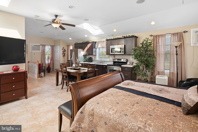 bedroom with an AC wall unit, ceiling fan, sink, and stainless steel refrigerator with ice dispenser