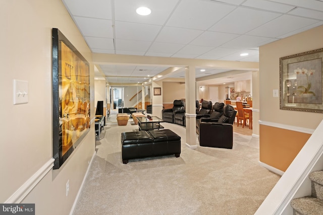 living room with light carpet and a drop ceiling