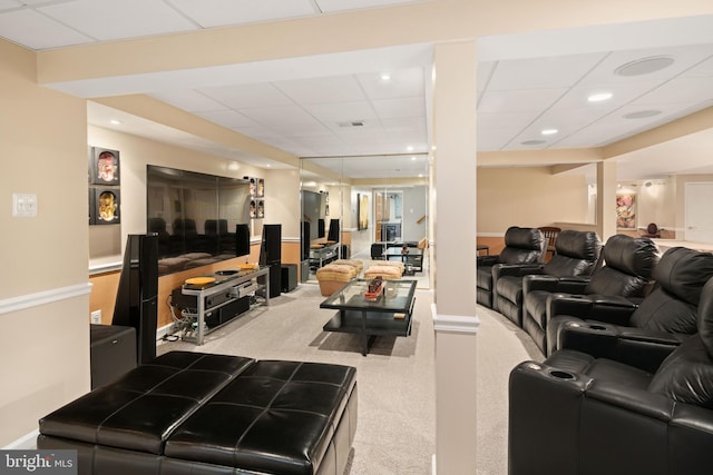 living room featuring a drop ceiling and light carpet