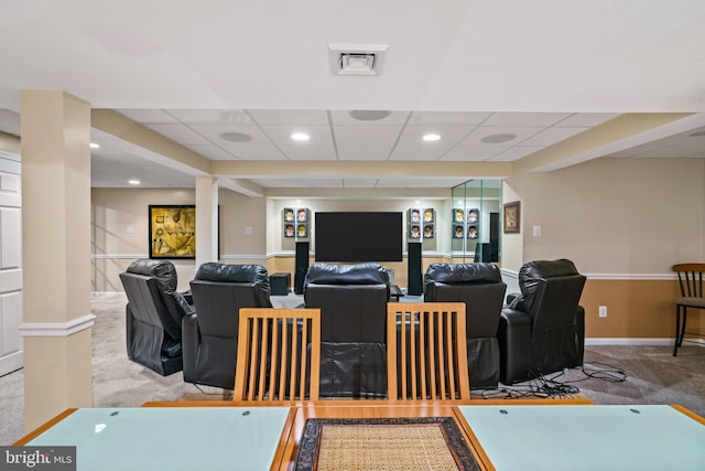 living room featuring light carpet and a paneled ceiling