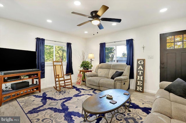 living room featuring light hardwood / wood-style floors, plenty of natural light, and ceiling fan