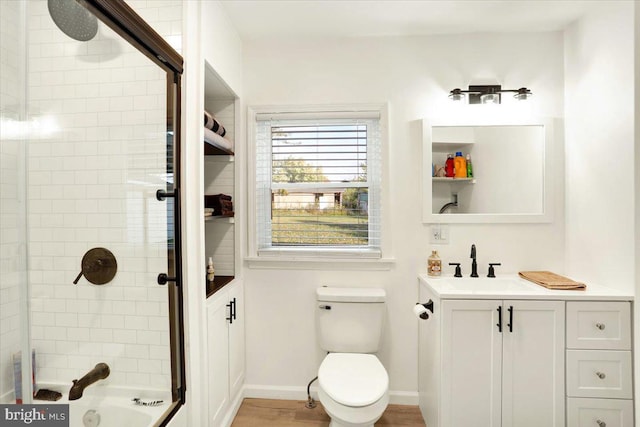 full bathroom with vanity, combined bath / shower with glass door, and toilet