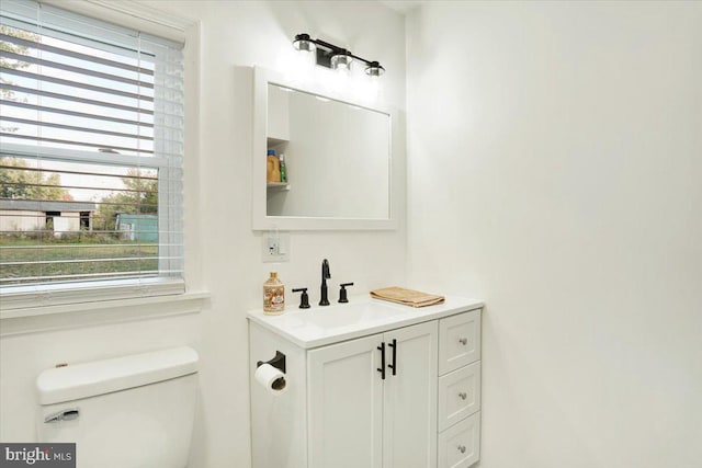 bathroom featuring vanity, toilet, and a wealth of natural light