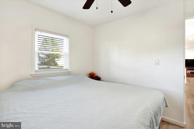 bedroom with light hardwood / wood-style flooring and ceiling fan