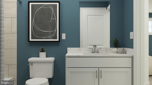 full bathroom featuring toilet and vanity