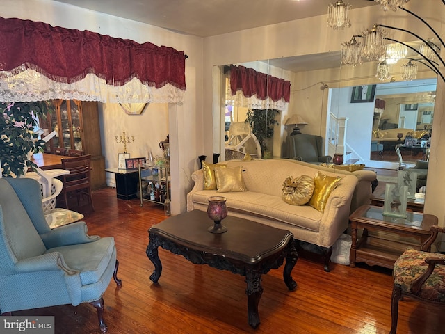 living room with hardwood / wood-style flooring and an inviting chandelier