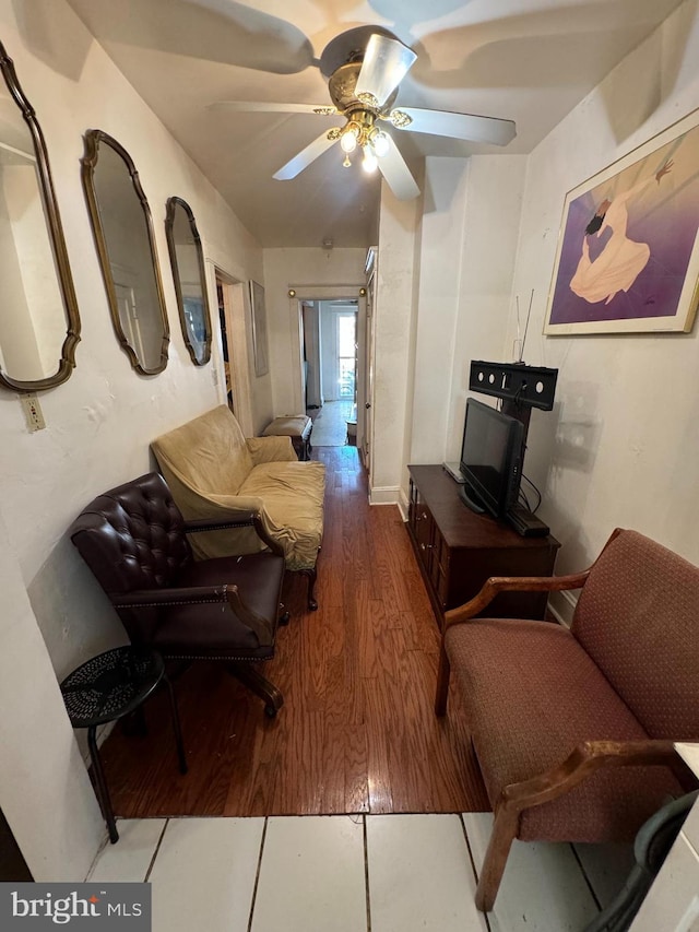 living room featuring hardwood / wood-style floors and ceiling fan