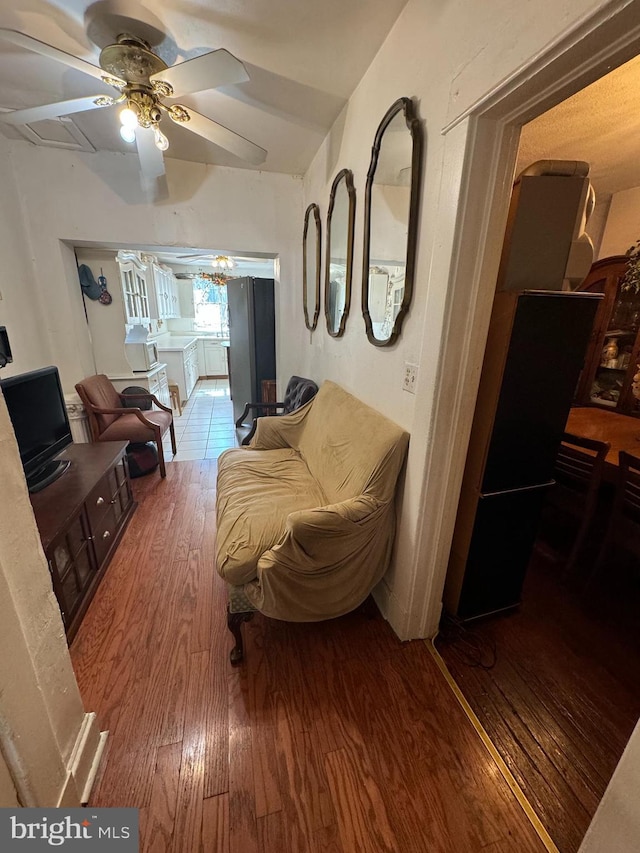 living room with hardwood / wood-style flooring and ceiling fan