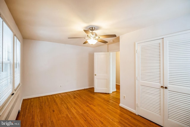 unfurnished bedroom with a closet, ceiling fan, and light hardwood / wood-style flooring