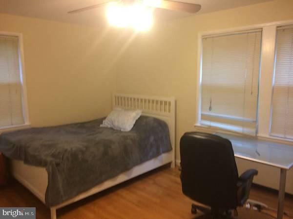 bedroom featuring hardwood / wood-style flooring and ceiling fan