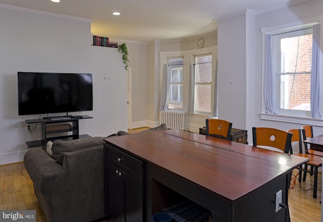 office area with crown molding, light hardwood / wood-style flooring, and radiator