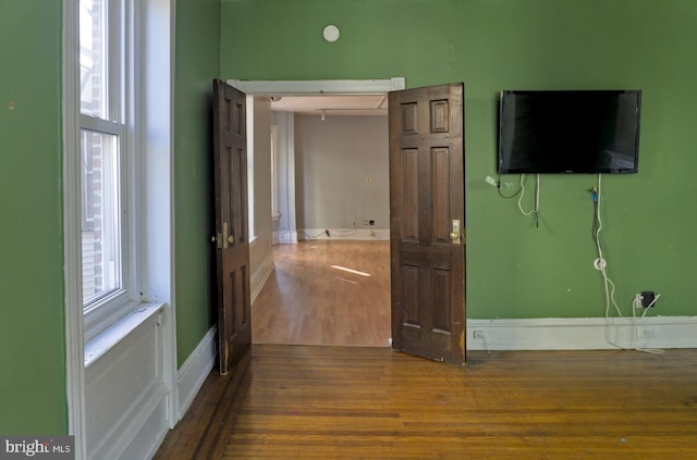 interior space with wood-type flooring and multiple windows