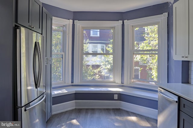 kitchen featuring appliances with stainless steel finishes, gray cabinets, and wood-type flooring