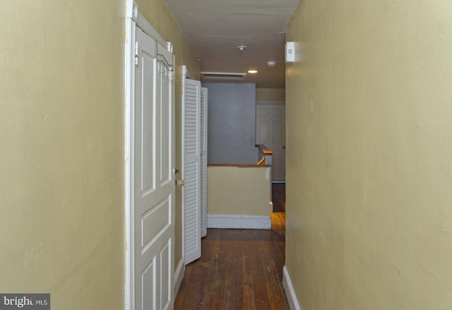 hall with dark hardwood / wood-style floors