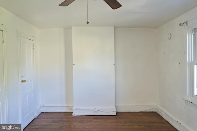 spare room with ceiling fan and dark wood-type flooring