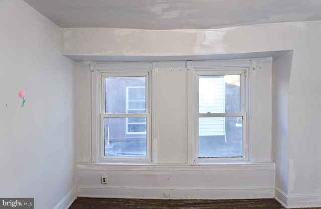 spare room with dark hardwood / wood-style flooring