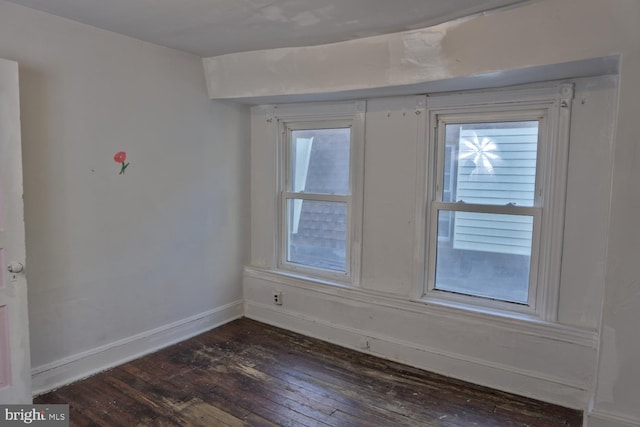 spare room with dark wood-type flooring