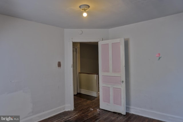 unfurnished room featuring dark hardwood / wood-style floors